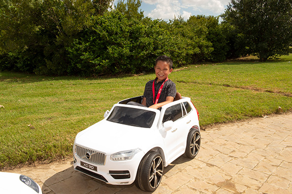 Nathan Prado drives a miniature Volvo XC90 battery-powered car