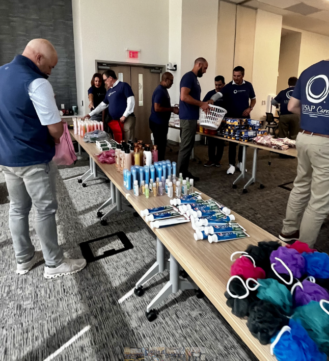 U.S. Anesthesia Partners volunteers pack bags of essentials for victims of domestic abuse.
(Courtesy USAP)